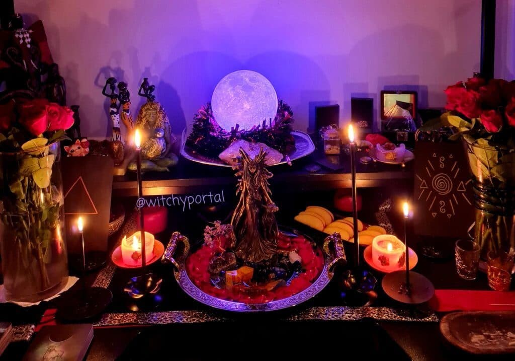 Candles, fruit and flowers laid out as offerings on an altar
